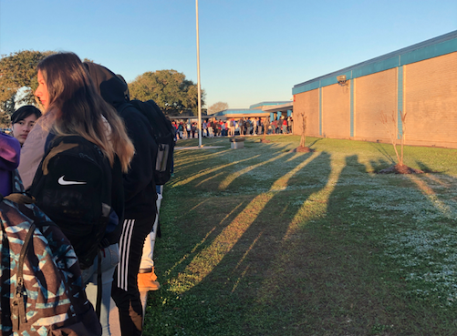 Nearly 20 minutes after classes started on Friday, Feb. 7, a long line of students are waiting to get into Beaumont ISD’s West Brook High School, where it’s the first day of a pilot program to utilize metal detectors to scan students entering the campus. 