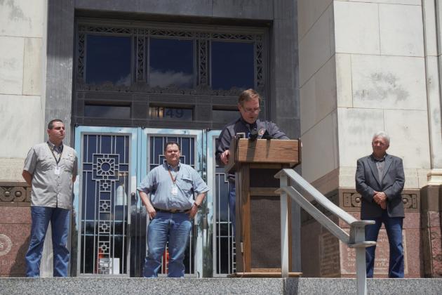 Jefferson Couty Judge Jeff Branick speaks on the couty courthouse steps, flanked by Orange County Judge John Gothia (right) and Hardin County Judge Wayne McDaniel (left). Jasper County Judge Mark Allen stands behind.
