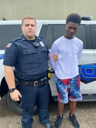 Arthur Small Jr, 18, pictured with an officer