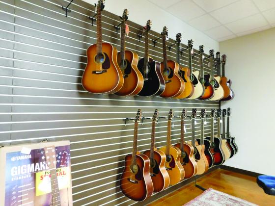 A wall of guitars in store.