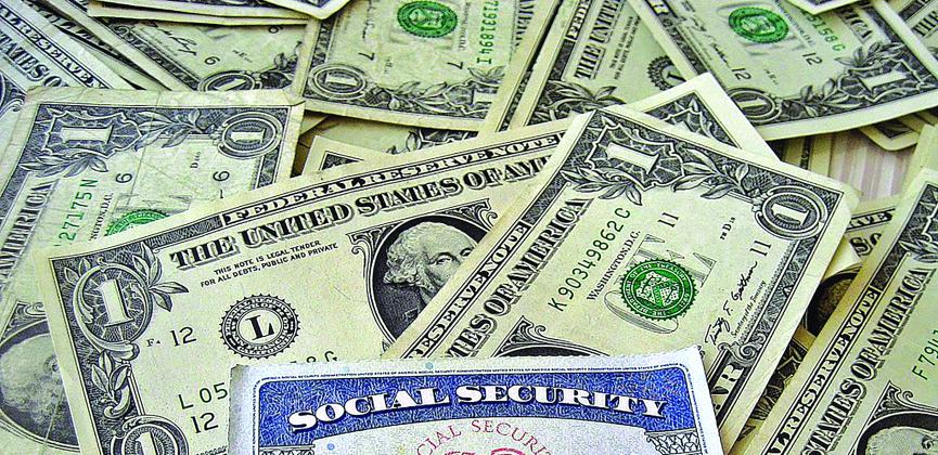 A shot of money with a social security card 