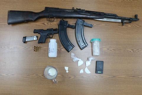 Weapons and drugs recovered at the scene.
