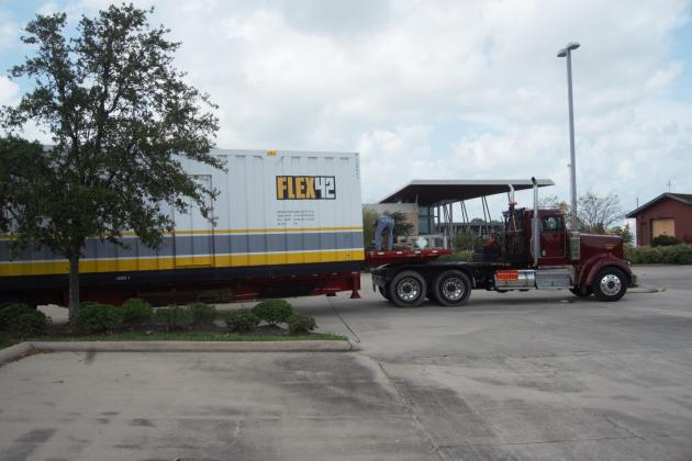 A driver prepares to unload a RedGuard temporary housing pod Aug. 31.