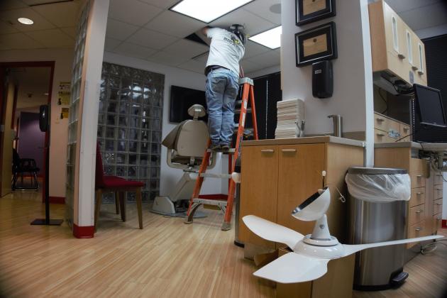 Big Ass Fans workers install UV fans at Dr. Caldwell's Harrison Avenue office