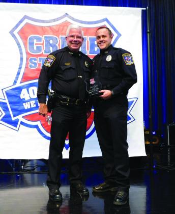 Vidor Police Department Chief Rod Carroll presents Reserve Officer Brodie Fischer with a Crime Stopper of the Year award.