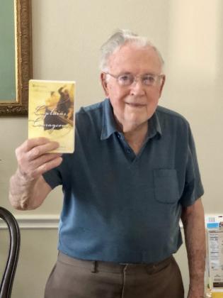 Guzardo stands with a copy of Rudyard Kipling's book, Captains Courageous