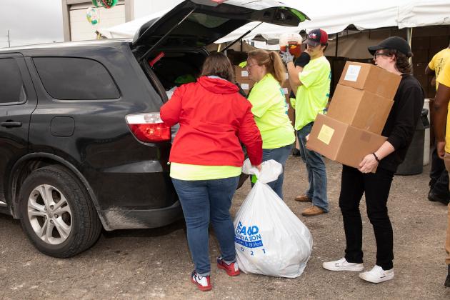 Volunteers help load items at Bicycles and Bibles