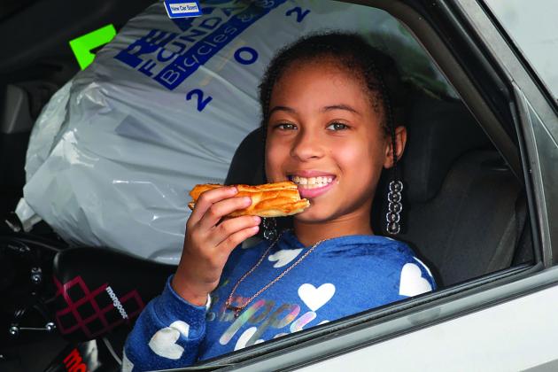 A young attendee to Bicycles and Bibles enjoys a piece of pizza