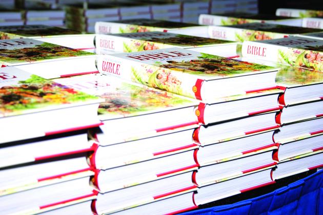 Stacks of children's Bibles given out at Bicycles and Bibles