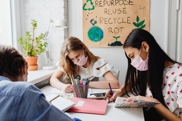 Students work in a classroom with masks on 