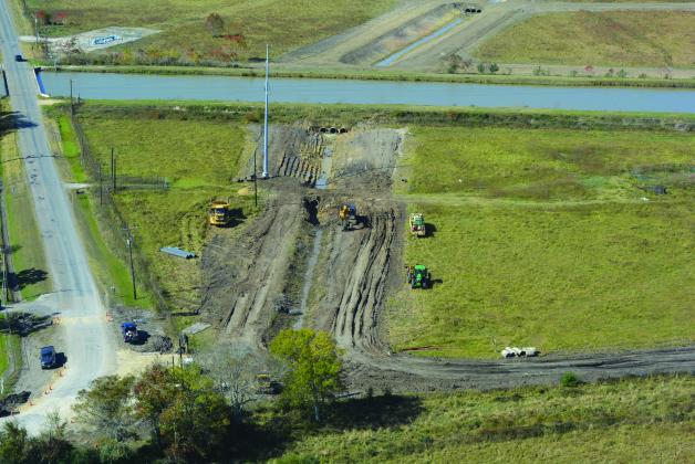 DD6 workers prepare to widen this ditch crossing from one smaller pipe to three larger pipes