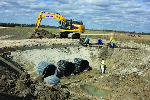 DD6 workers clear and widen a crossing along Byrd Gully 