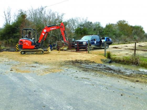 DD6 workers finish up a private road built in exchange for easement