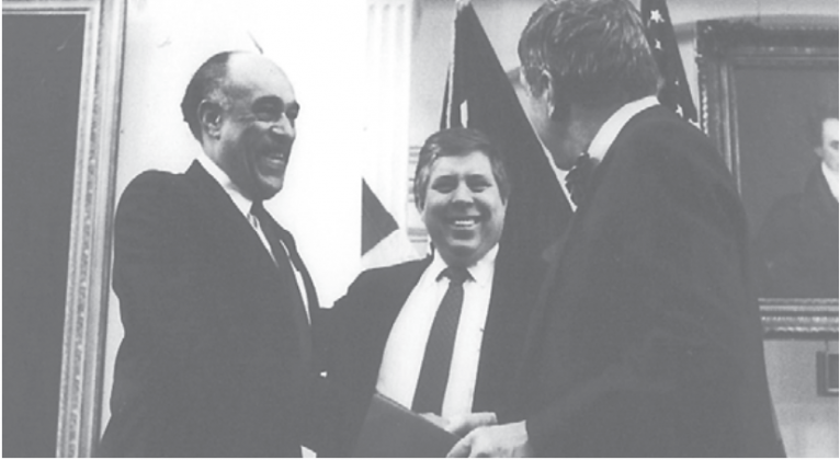 Elmo Willard (left), honored by the Texas Senate, is congratulated by former Lt. Gov. Bill Hobby (right) and Sen. Carl Parker (center). 