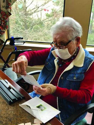 A Buckner Senior Living Community resident opening a valentine.