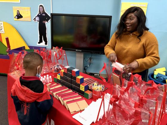A child interacts with an adult at Lemonade Day 