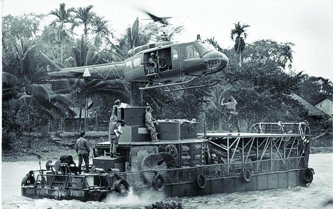 A medical evacuation helicopter, landing on Houp’s small flattop to take the wounded to medical care.’ The majority of the time, we could wait until we reached a somewhat larger stream as depicted here,’ he said. ‘There were, however, times these brave helicopter crews came in during action to get our wounded to the care they needed to survive.’