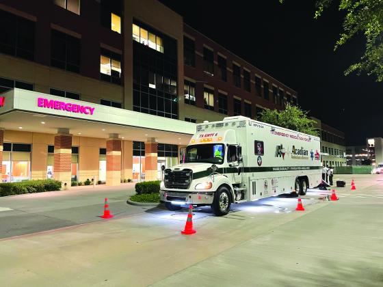 An emergency vehicle surrounded by cones.