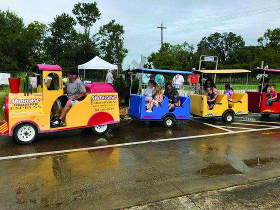 People ride a train for Depot Day in Orange 