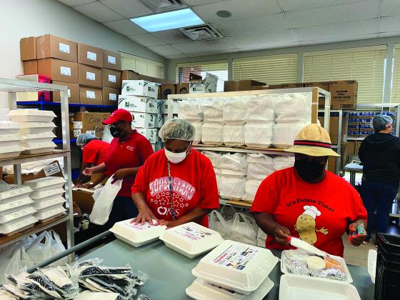 Workers pack meals