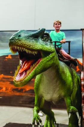 Child riding a T-Rex dinosaur
