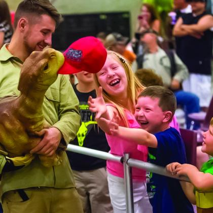 Dinosaurs interacting with kids