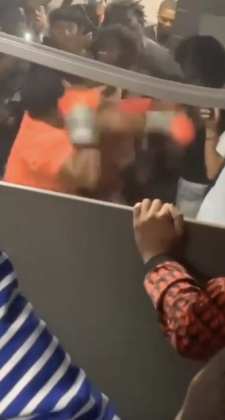 An orange-gloved teen lands a punch on another.