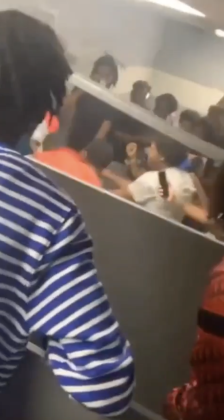An apparent student referee attempts to halt a boxing match held in a West Brook bathroom.