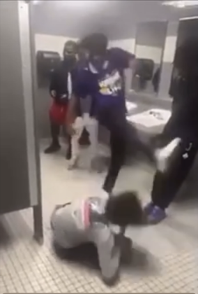 The aggressor finishes his assault  with a kick to the head.