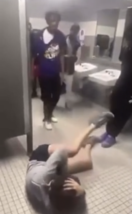 A West Brook student lies on the floor after being assaulted by the teen in purple.