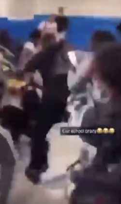 Students can be seen fighting after a kid throws a trash can.
