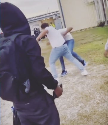 A screenshot  from video sent by a senior at West Brook depicts two students in a fight outside