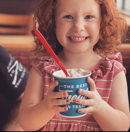 A child holds a Dairy Queen blizzard