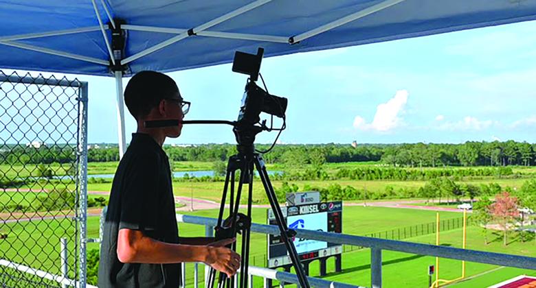 A BISD student films a home football game 