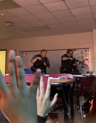 BPD officers tell students to put their hands up as they check the classroom for a gunman