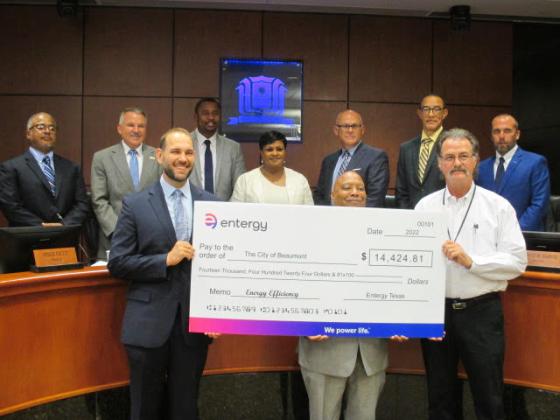 City of Beaumont employees pose with a check from Entergy
