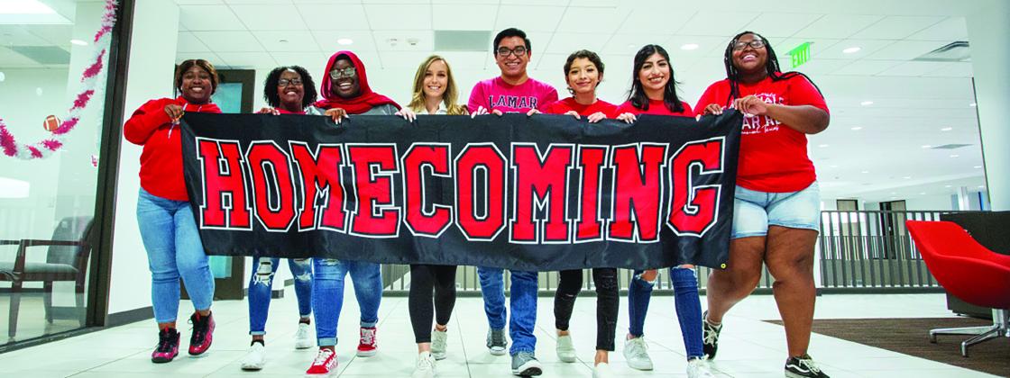 Lamar students hold the Lamar Homecoming banner 