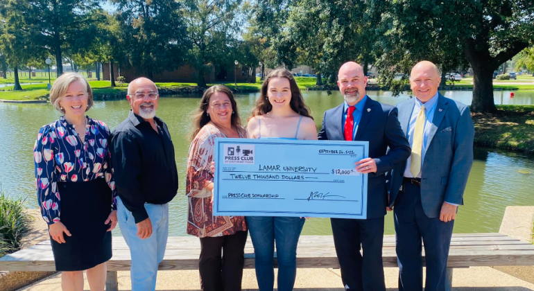 Southeast Texas Press Club members present a $12,000 check. 