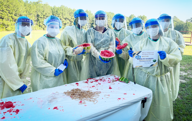 Silsbee High School students in PPE pose with crushed watermelon pieces 