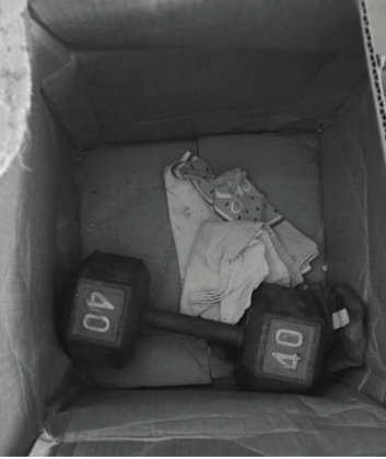 A box with a dumbbell in it that should have been pieces of gold