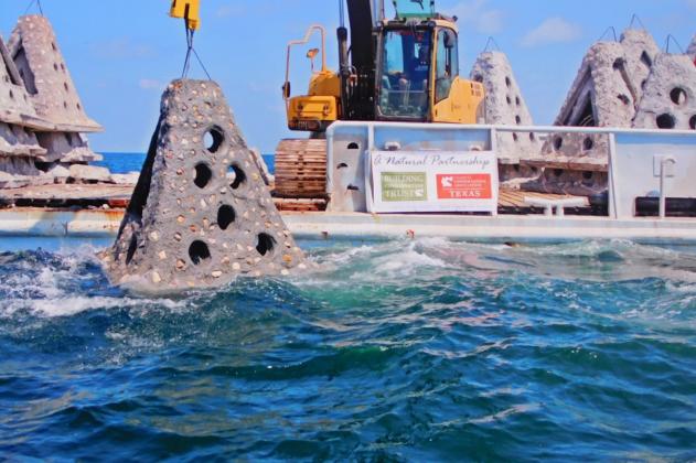 Artificial reef being lowered into the water 