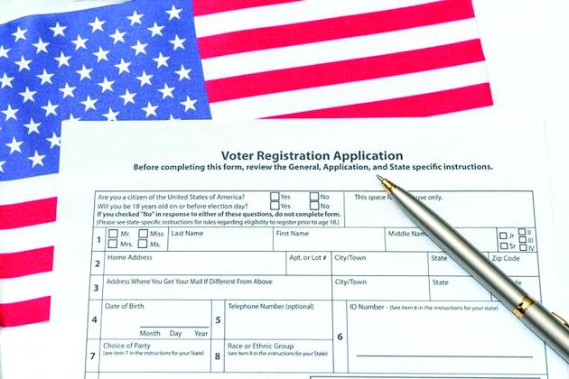 A sample voter registration form on an American Flag