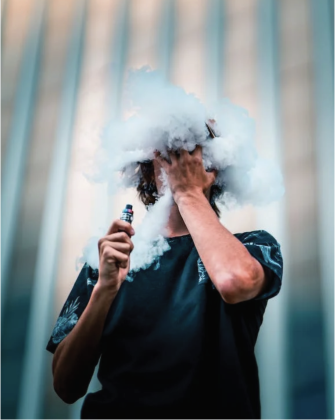 Person blowing a large vape cloud