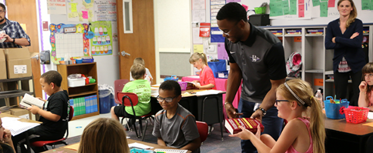 Students in a classroom with a teacher 