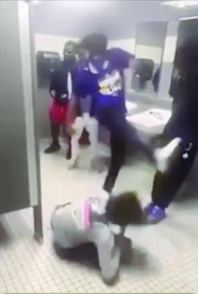 Savoy (in purple) kicks another student in a West Brook bathroom.
