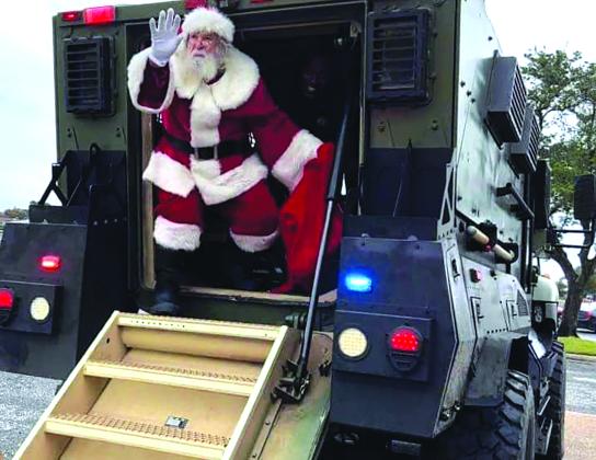 Santa on the back of a SWAT vehicle 