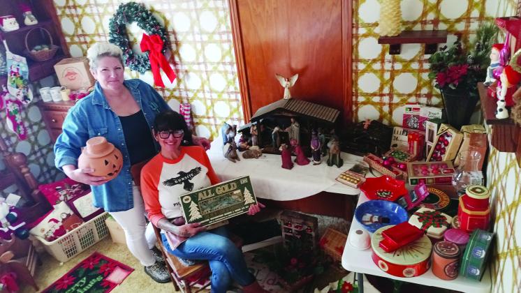 Left to right, Trisha Faye Callaway and Stephanie Comeaux at their staged estate sale on Dec. 6. Item in the left photo is a working 1966 manual Smith Corona Classic. In the above photo, they are posed in a ‘holiday room,’ with  items ranging  from Halloween to Christmas decorations.