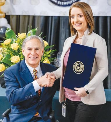Gov. Gregg Abbott, left, presents award to Nederland ISD teacher Jenna Dean
