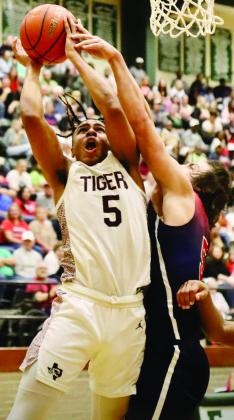 Silsbee's Jerrick Harper (5) goes up for a basket against H-J's Wyatt Samaha. Photo courtesy of Silsbee ISD