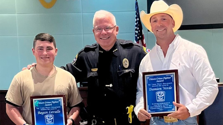 Police Chief Rod Carroll, center, Explorer Regan Lavallee and Damien Verde